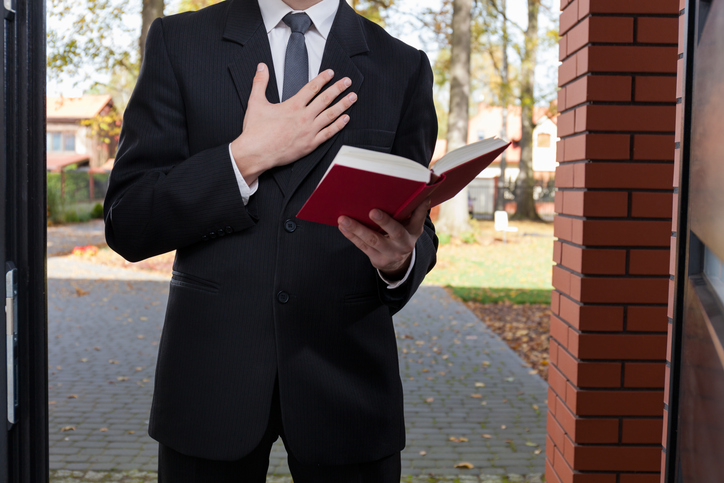 Jehovah's Witness reading a bible - Jehovah's Witness Sexual Abuse Lawyer