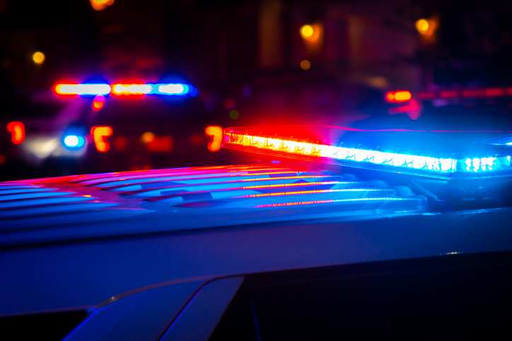 Police car lights at night - can you get arrested for an out-of-state warrant?