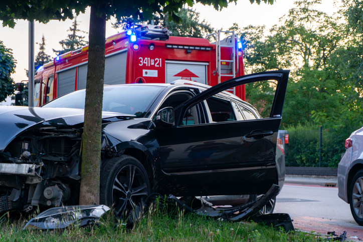 Damaged passenger car after road accident, fire department on the scene - How to obtain a car accident police report