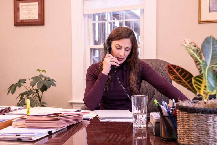 Attorney Heather Menezes taking a phone call at Shaheen & Gordon - What happens after deposition in a personal injury case?