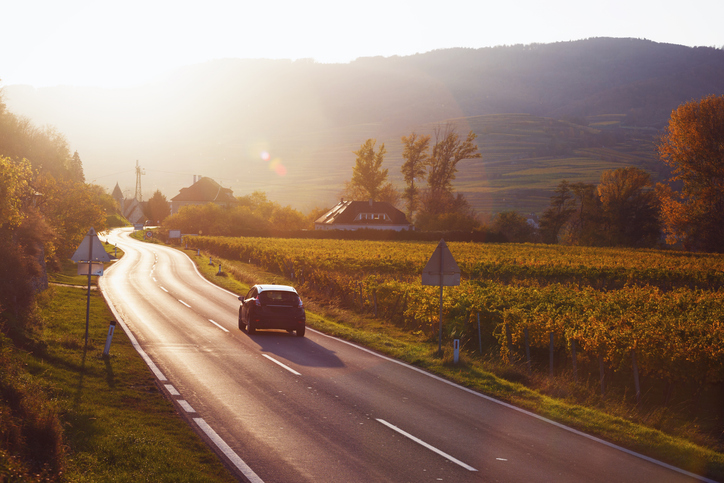 Car driving on road at sunset - Do car accidents increase after daylight saving time?